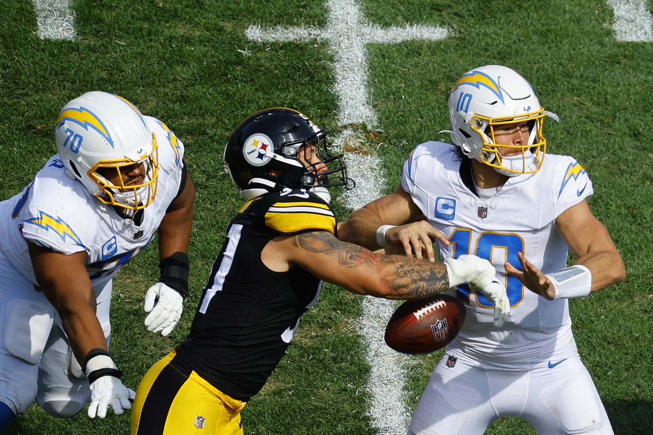 Nick Herbig #51 of the Pittsburgh Steelers forces a fumble on quarterback Justin Herbert #10 of the Los Angeles Chargers during the third quarter at Acrisure Stadium on September 22, 2024 in Pittsburgh, Pennsylvania.