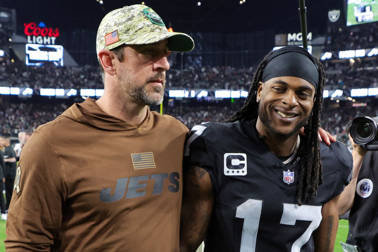 Quarterback Aaron Rodgers #8 of the New York Jets and wide receiver Davante Adams #17 of the Las Vegas Raiders visit on the field after the Raiders’ 16-12 victory over the Jets at Allegiant Stadium on November 12, 2023 in Las Vegas, Nevada.  &nbsp;   