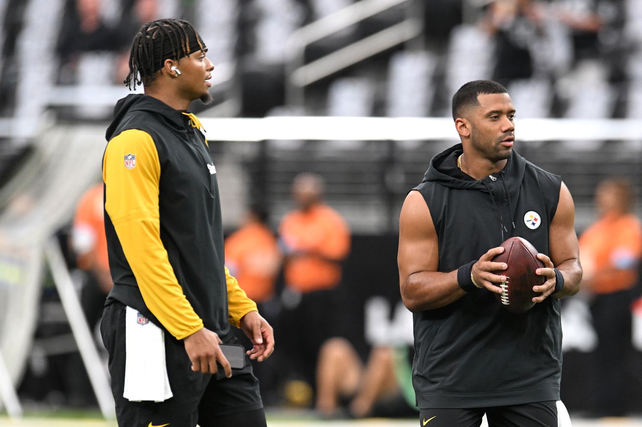 Justin Fields #2 and Russell Wilson #3 of the Pittsburgh Steelers warm-up prior to a game against the Las Vegas Raiders at Allegiant Stadium on October 13, 2024 in Las Vegas, Nevada.