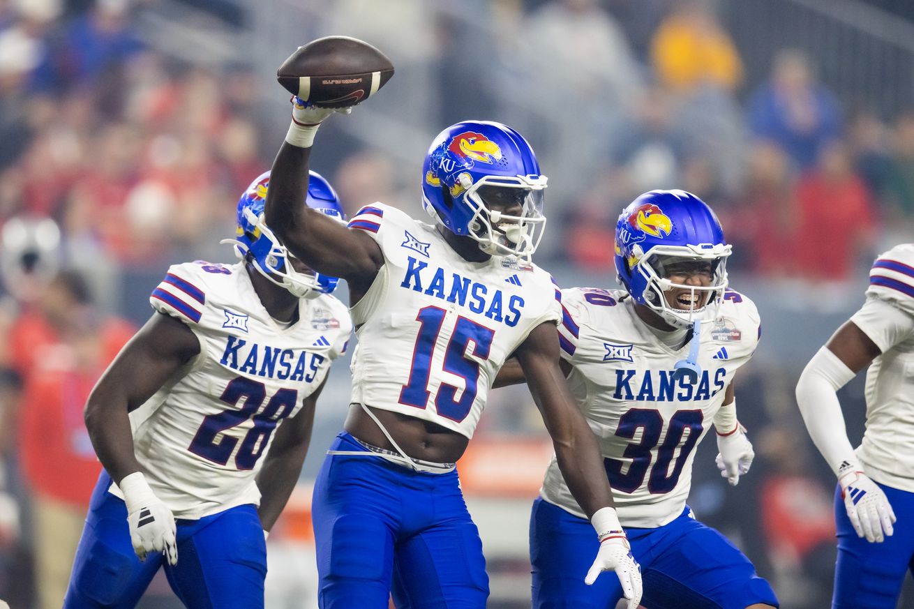 Kansas Jayhawks linebacker Craig Young (15) and Rich Miller Jr. (30) celebrate a play against the UNLV Rebels in the Guaranteed Rate Bowl at Chase Field.&nbsp;