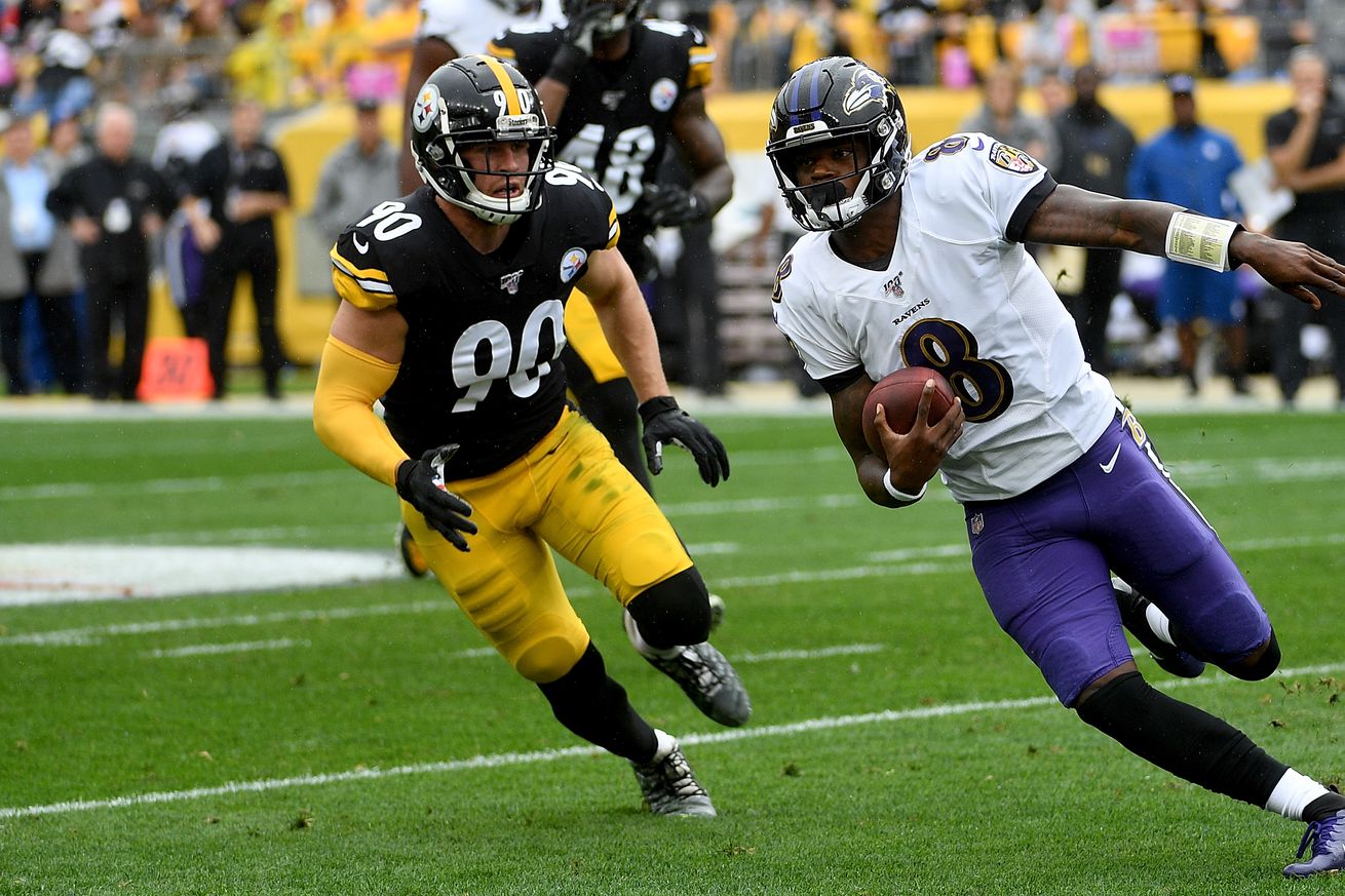 Lamar Jackson #8 of the Baltimore Ravens scrambles under pressure from T.J. Watt #90 of the Pittsburgh Steelers in the first quarter during the game at Heinz Field on October 6, 2019 in Pittsburgh, Pennsylvania.