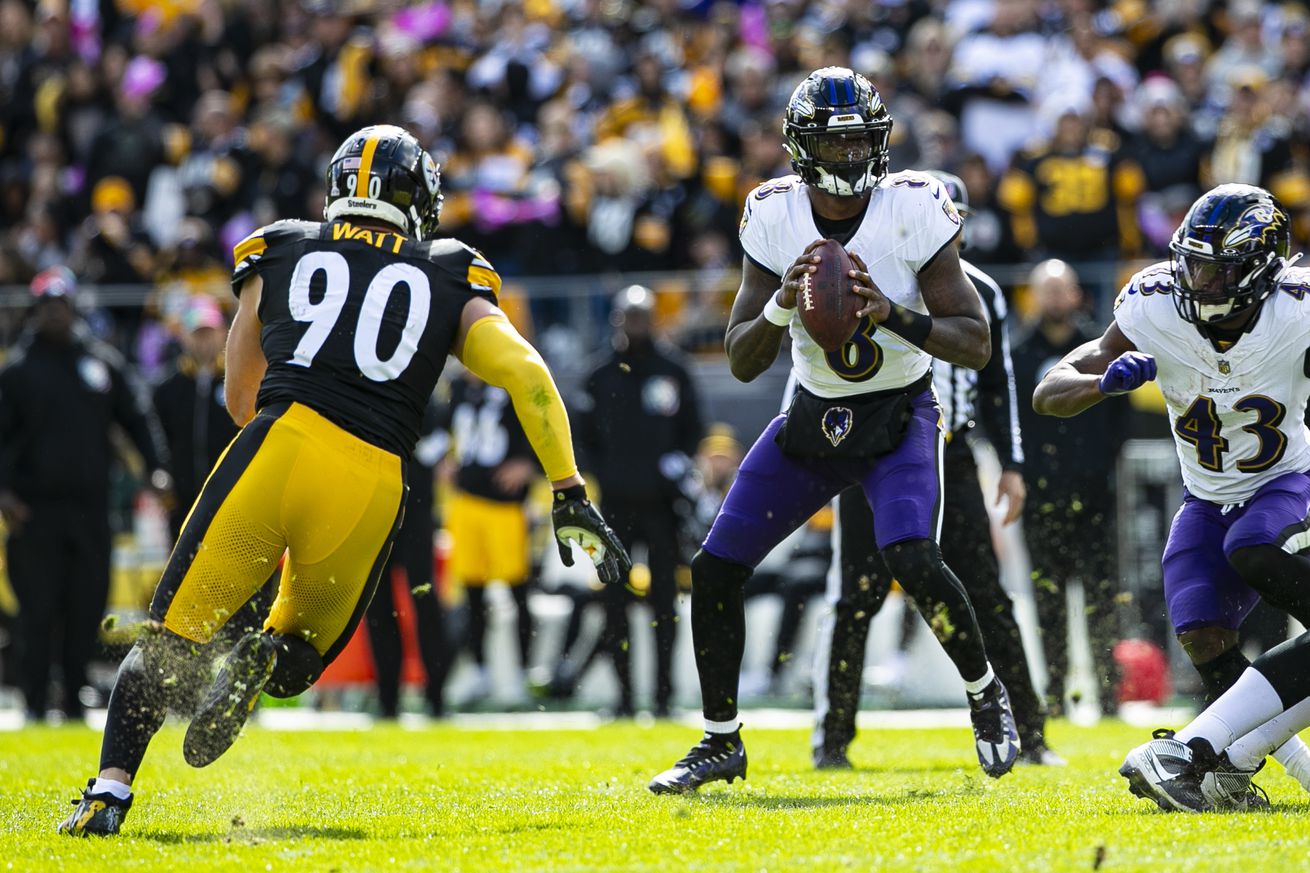 Pittsburgh Steelers linebacker T.J. Watt rushes Baltimore Ravens quarterback Lamar Jackson during a 2023 regular season contest between two rivals. 