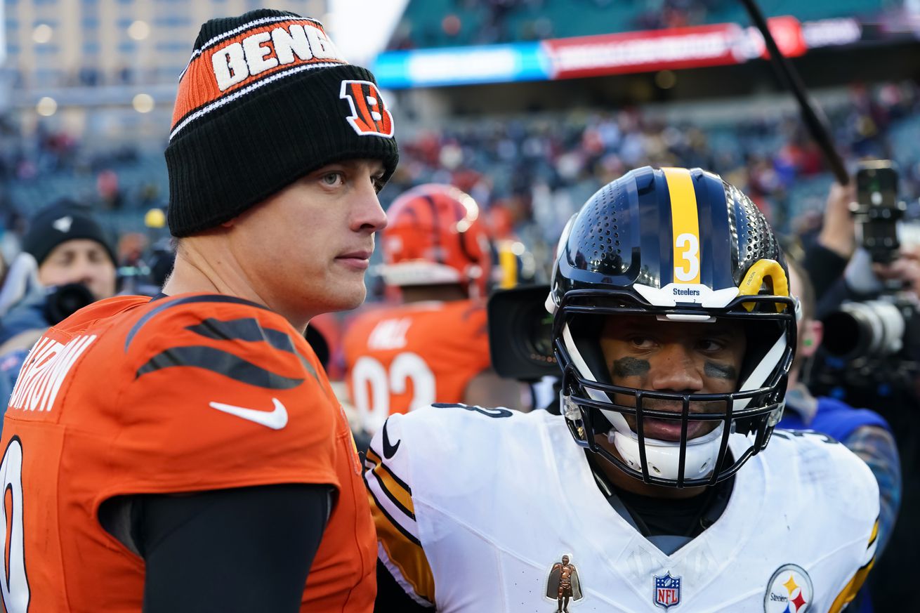 Joe Burrow #9 of the Cincinnati Bengals and Russell Wilson #3 of the Pittsburgh Steelers meet after the Steelers beat the Bengals 44-38 at Paycor Stadium on December 01, 2024 in Cincinnati, Ohio.