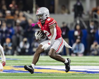 Ohio State wide receiver Emeka Egbuka carries the ball during the 2025 Goodyear Cotton Bowl Classic against the Texas Longhorns. 