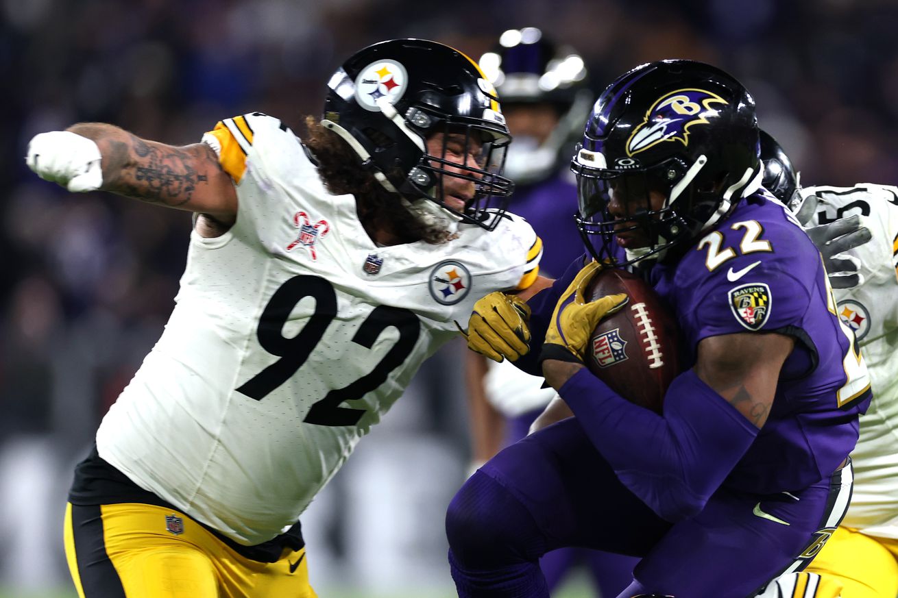 Derrick Henry #22 of the Baltimore Ravens is tackled by Isaiahh Loudermilk #92 of the Pittsburgh Steelers during the third quarter at M&amp;T Bank Stadium on December 21, 2024 in Baltimore, Maryland.